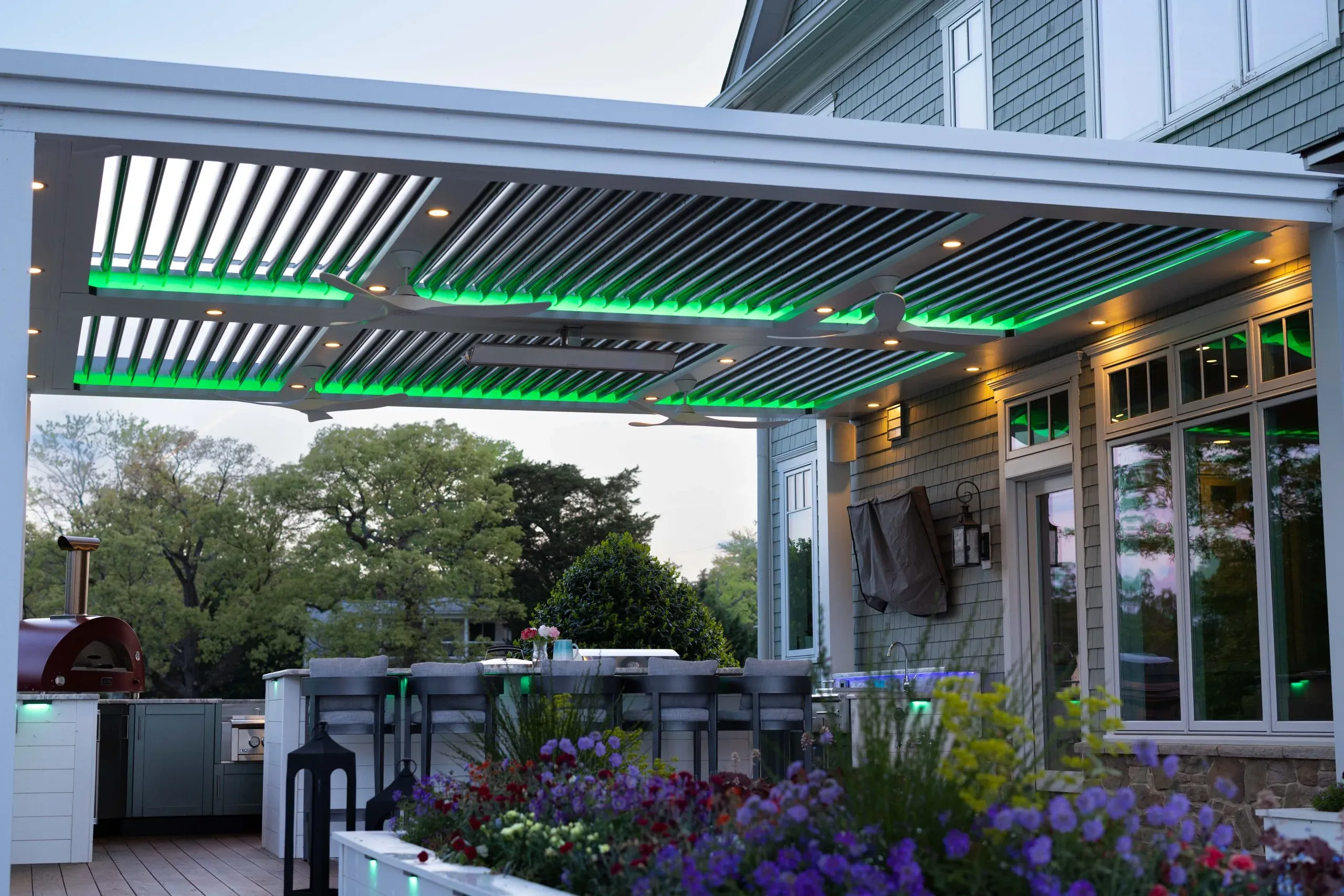 Louvered pergola over an outdoor kitchen and bar
